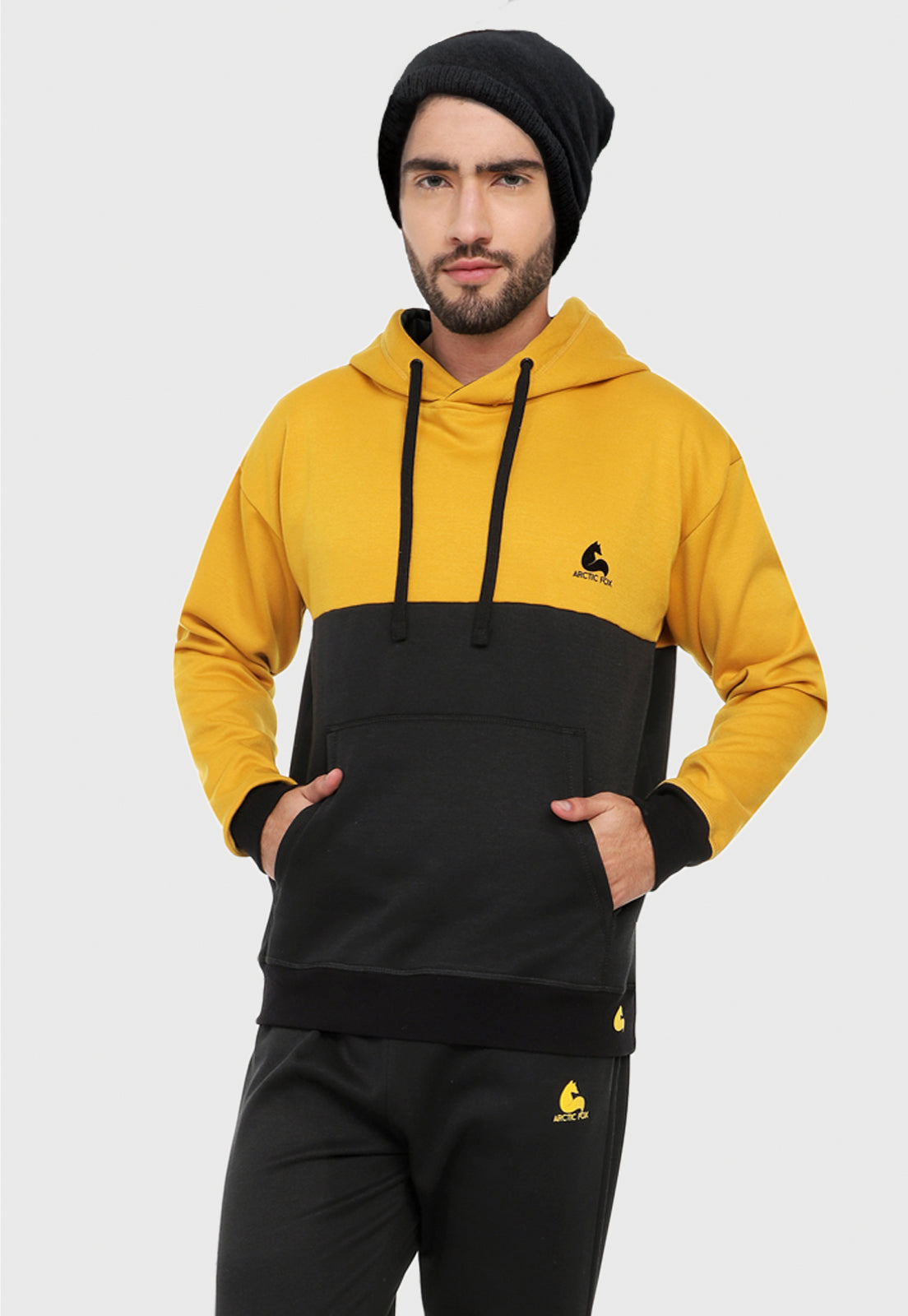 Hombre vistiendo el buzo hoodie mostaza y negro para hombre corte inglés.